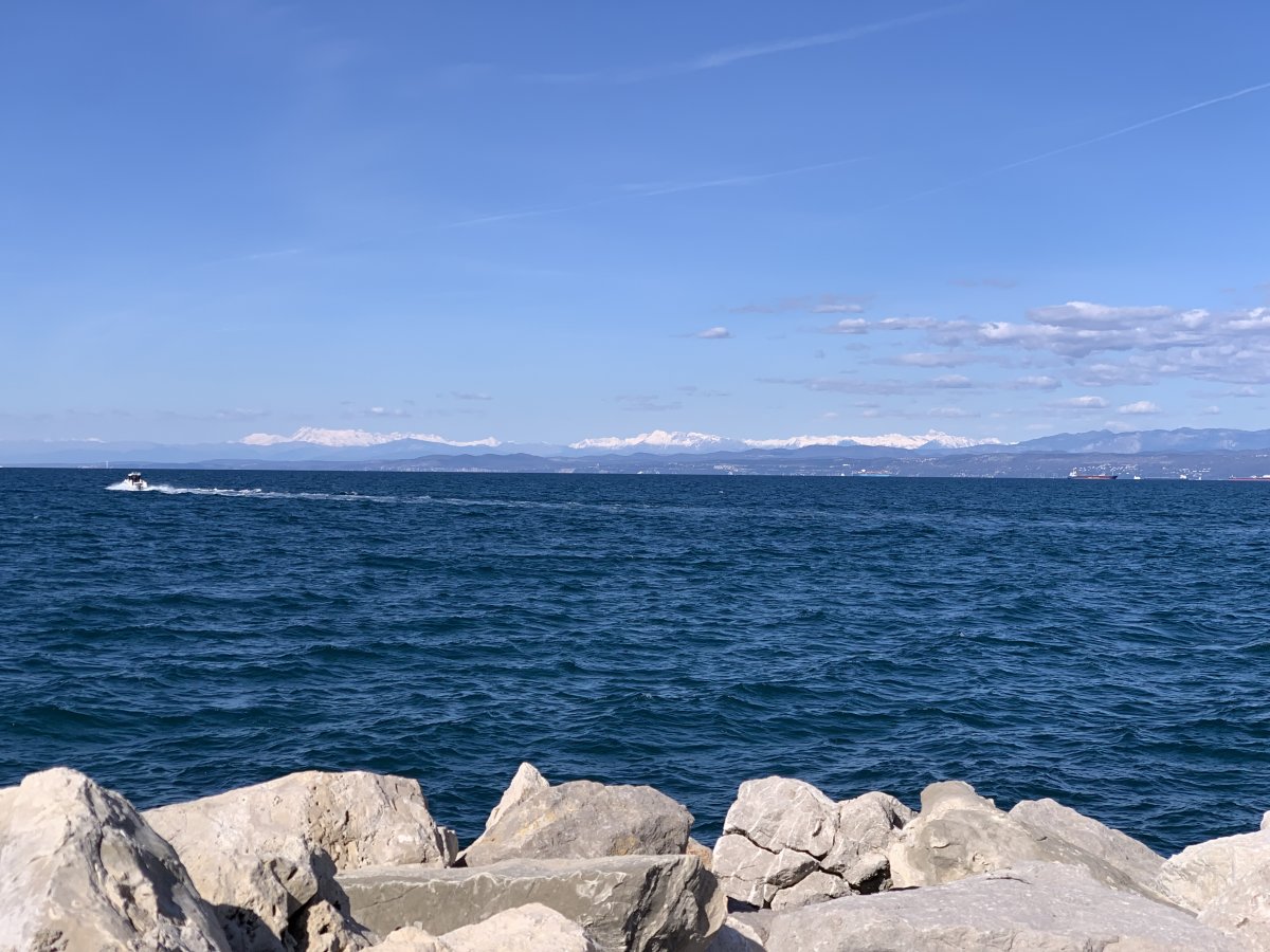 Green Slovenia is so rinky dinky small you can easily see the main snow covered Alps here from the coast at Izola!